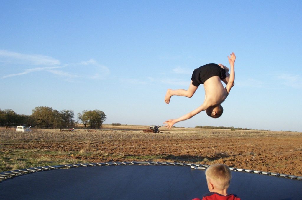 Boy jumping on trampoline