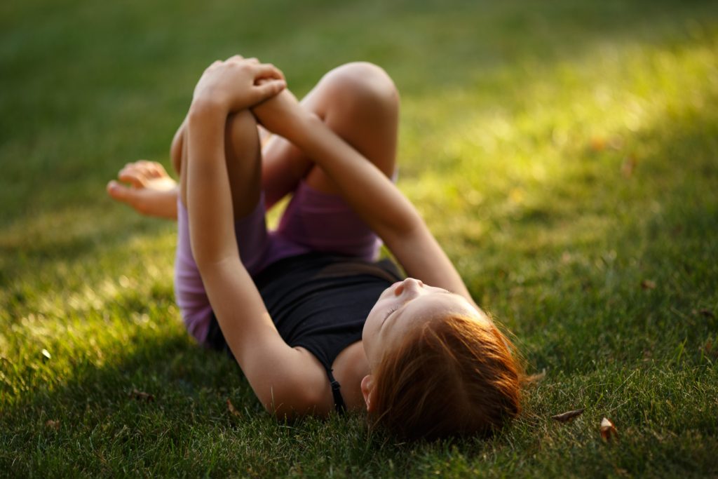 Girl lying in grass